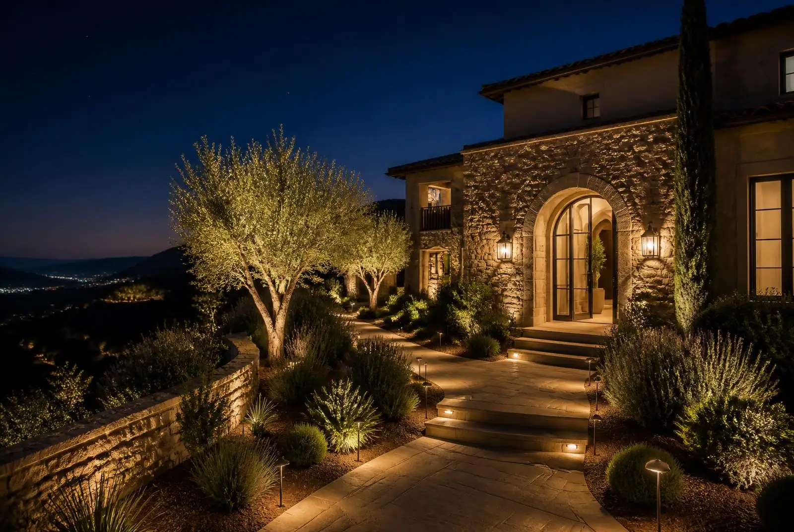 Rancho Palos Verdes hillside Mediterranean home with uplit stone entry at night