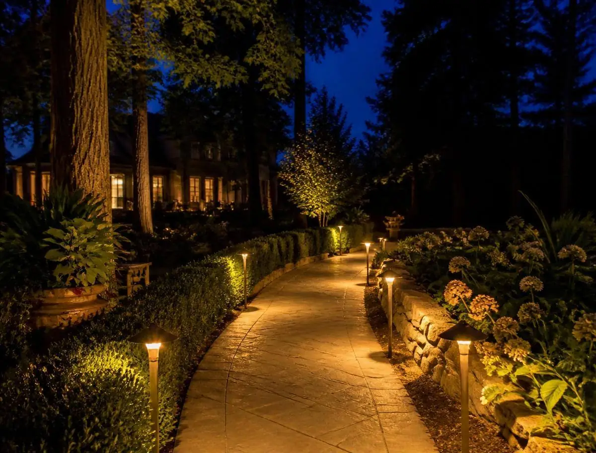 Technician-serviced pathway lighting glowing at night